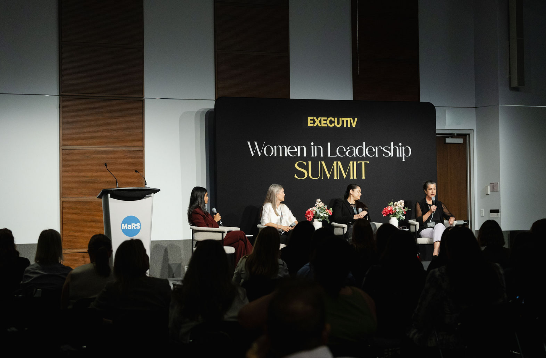 Executiv Women in Leadership Summit panel discussion on stage